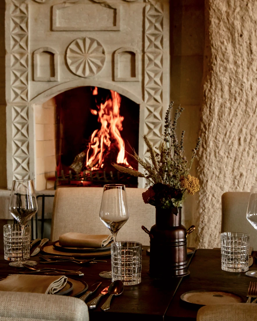 Stone hearth with lit fireplace at Argos in Cappadocia
