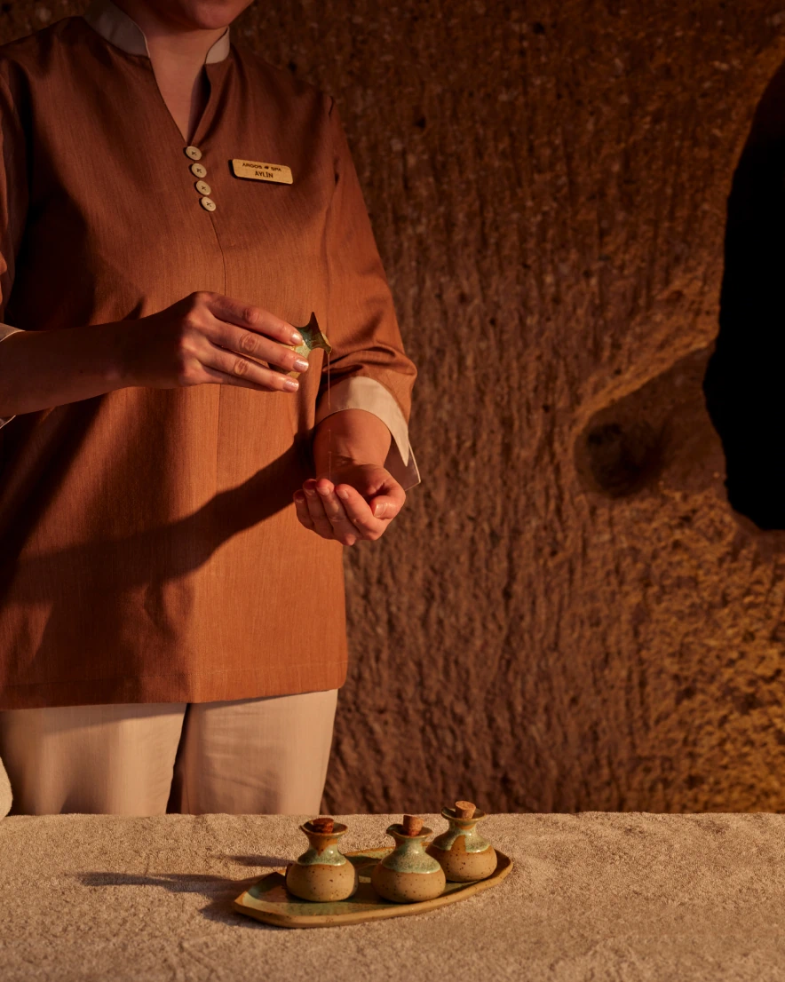 Robed guest in the cave spa ambiance at Argos in Cappadocia