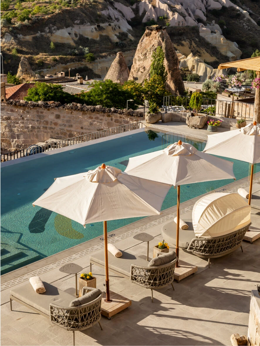 Shaded pool terrace with Cappadocia view at Argos in Cappadocia
