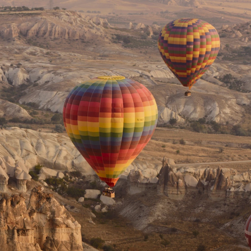Hot air balloons drifting over Cappadocia from Argos in Cappadocia