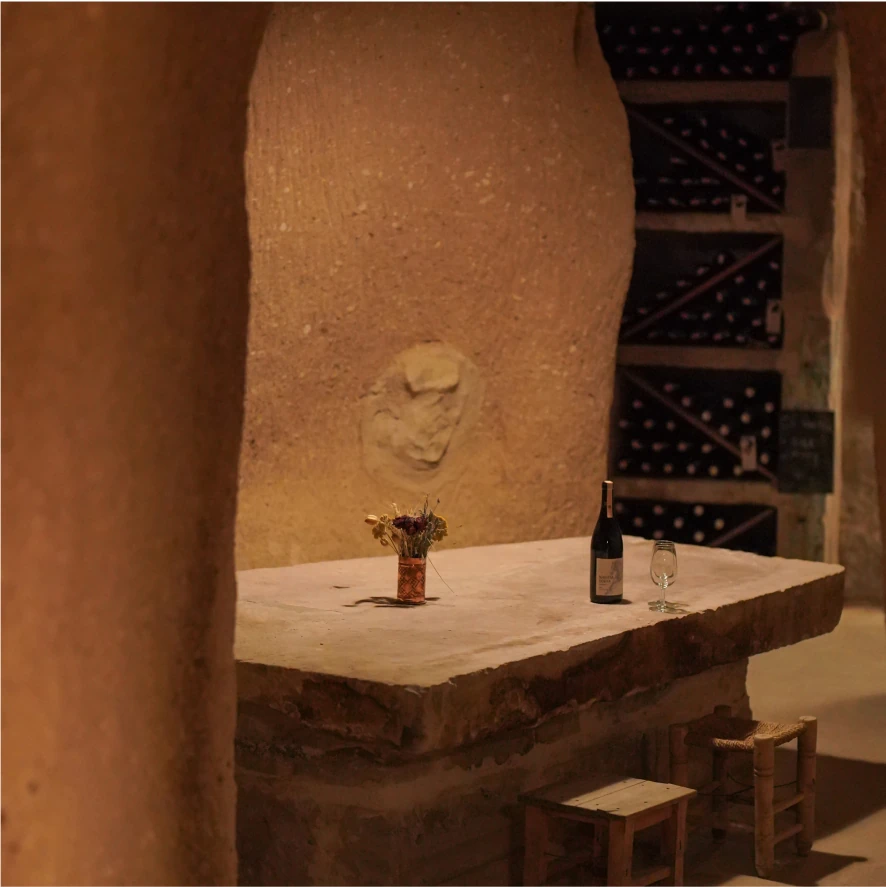 Wine racks and stone wall in the Bezirhane cellar, Argos in Cappadocia