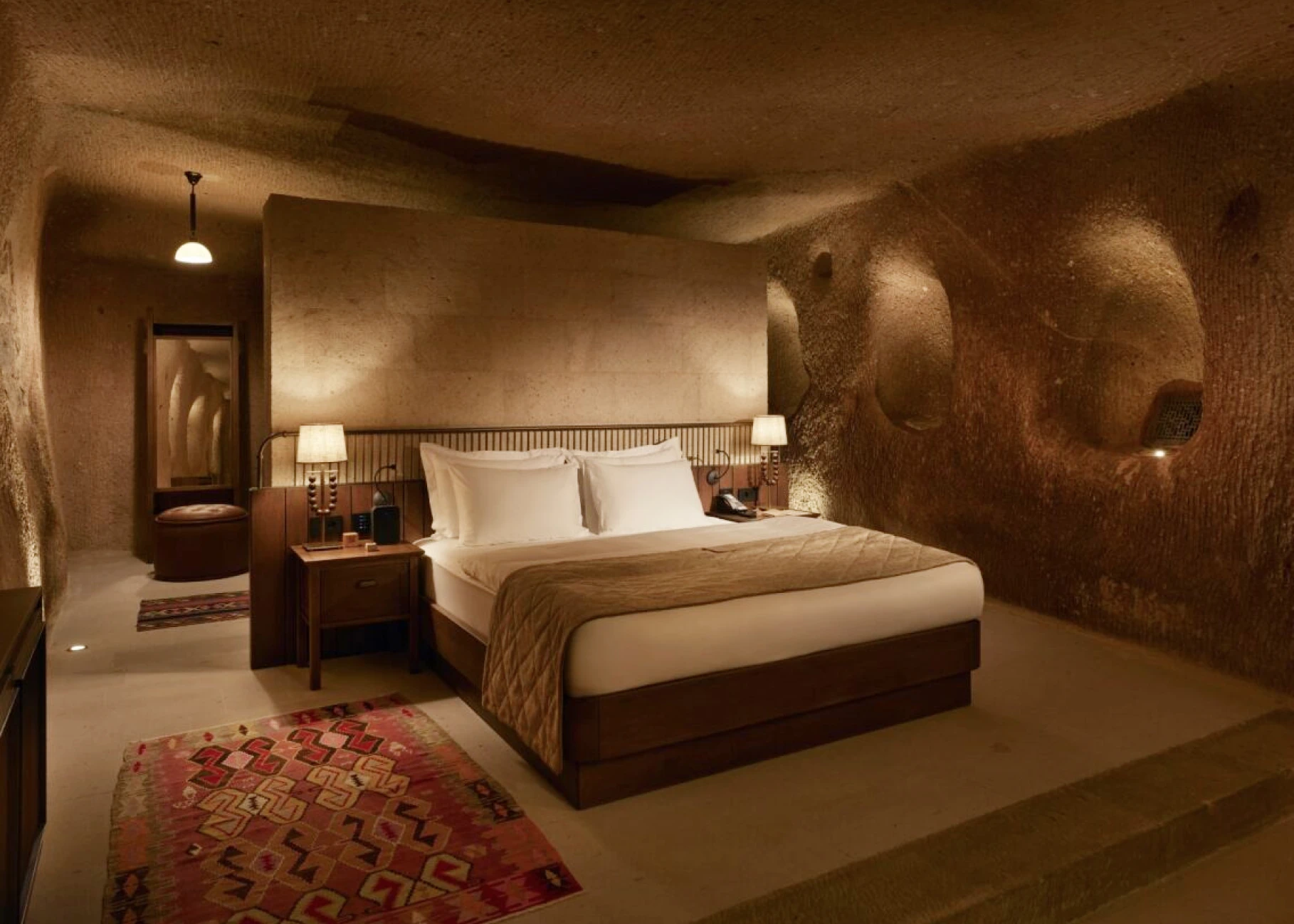 Vaulted stone ceiling and bed in an Argos in Cappadocia suite